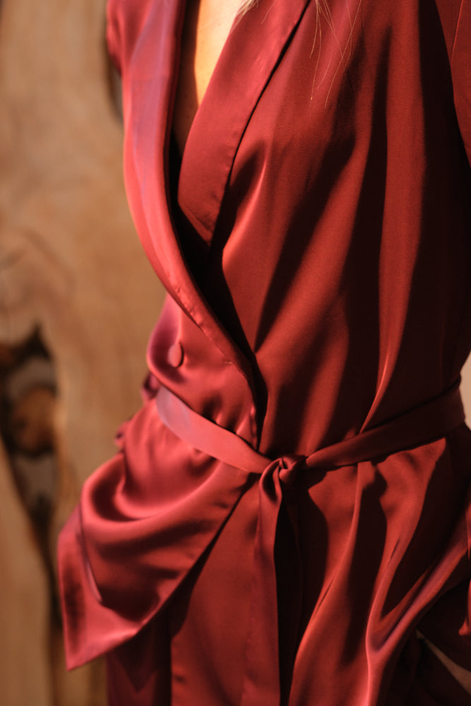 Burgundy satin fabric texture luxury tailoring detail